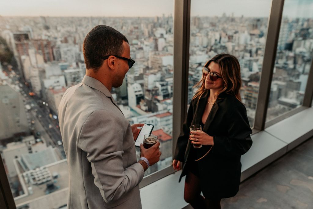 A stylish evening social event with a city view from a skyscraper in Buenos Aires.